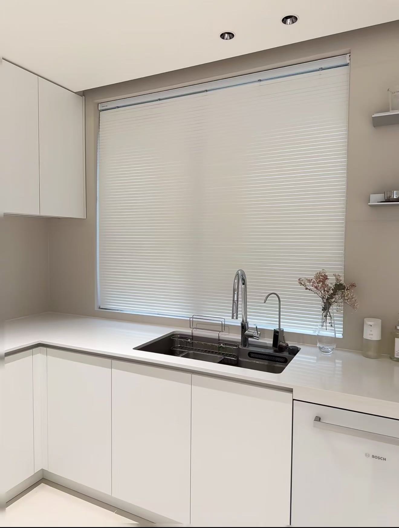 White honeycomb blind over a kitchen sink
