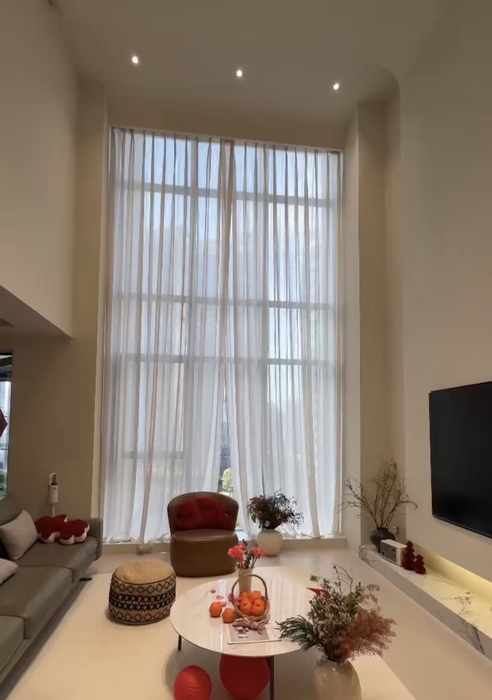 Full-height sheer curtains in a living room