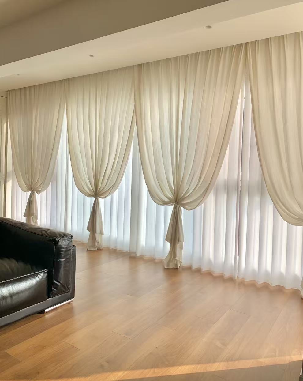 Sheer curtains dressed with soft tiebacks