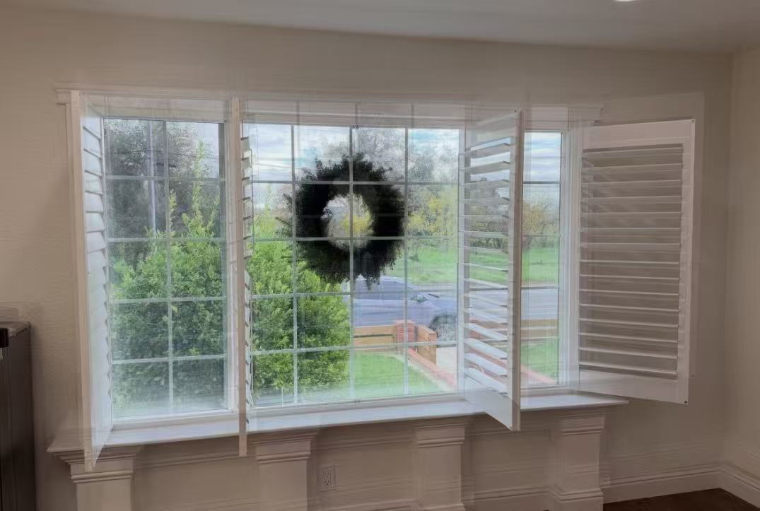 Plantation shutters fitted to a bay window