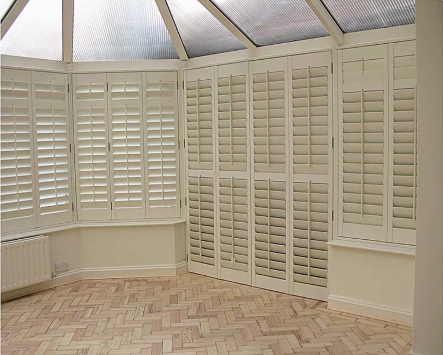 Full-height plantation shutters around a conservatory