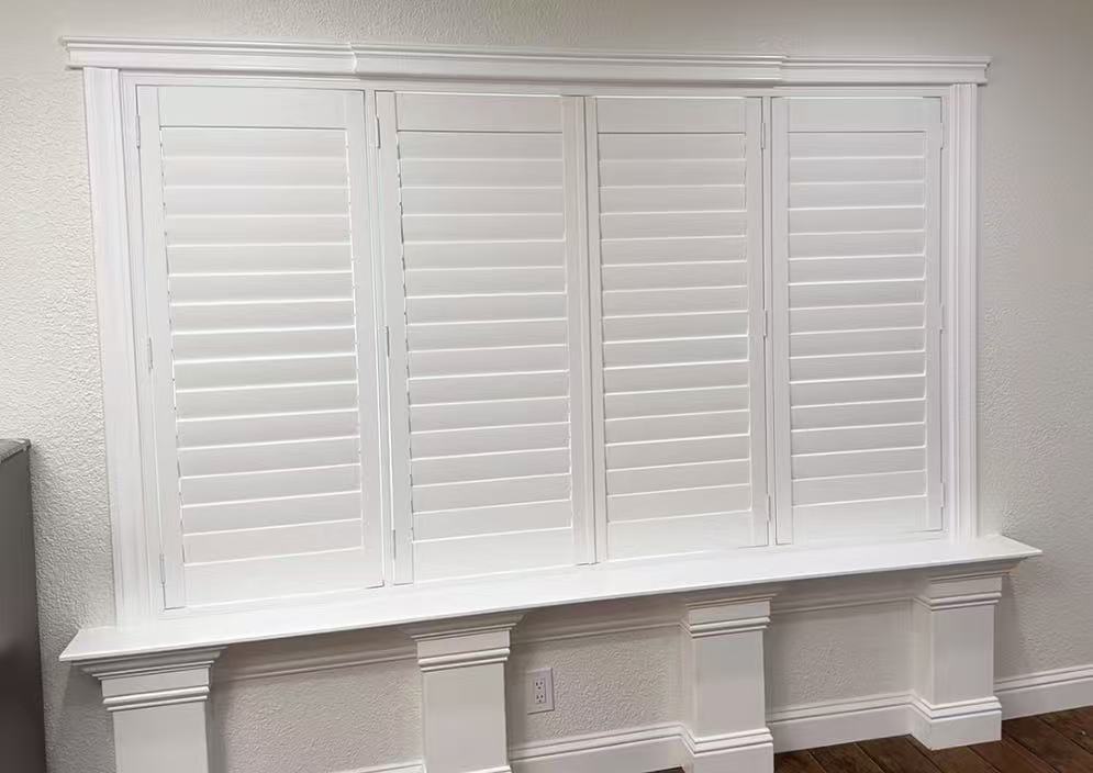 White plantation shutters over a window seat