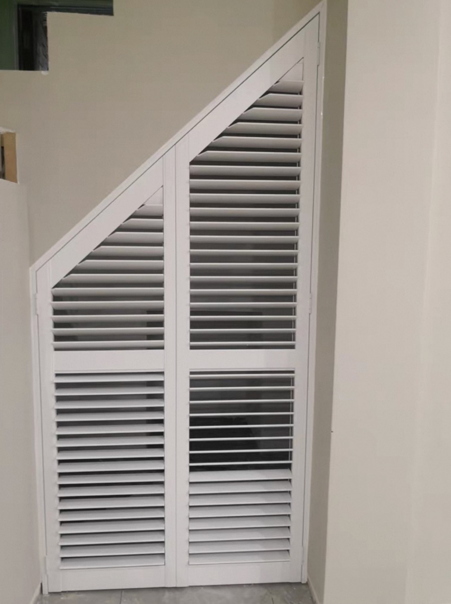 Angled raked shutters cut to a sloped ceiling