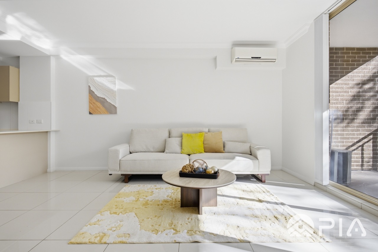 Airbnb lounge styled with bouclé sofa and abstract art