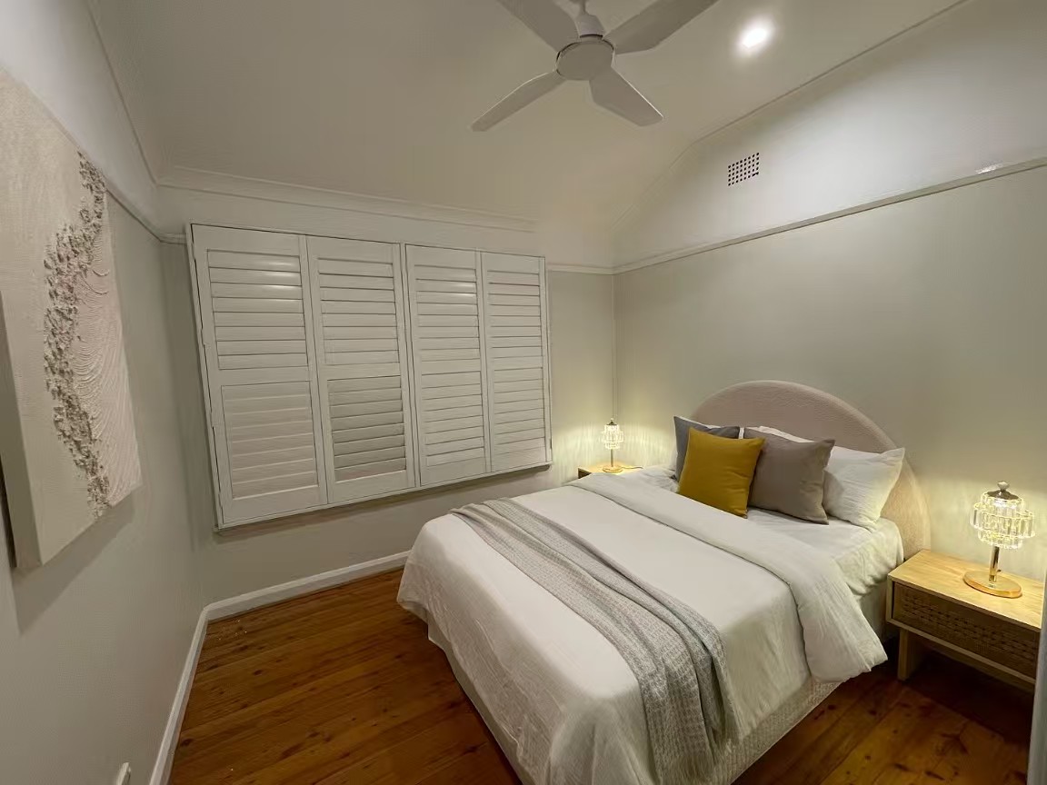 Bedroom with arched headboard and warm lamplight