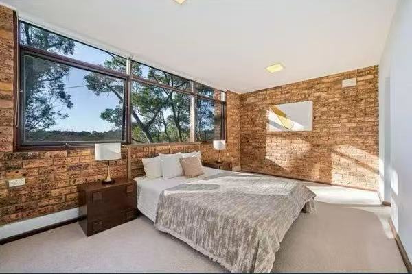 Bedroom with exposed brick feature wall