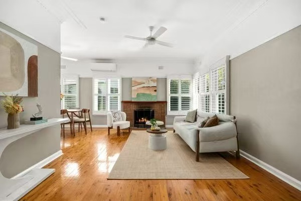 Styled living room with fireplace and plantation shutters