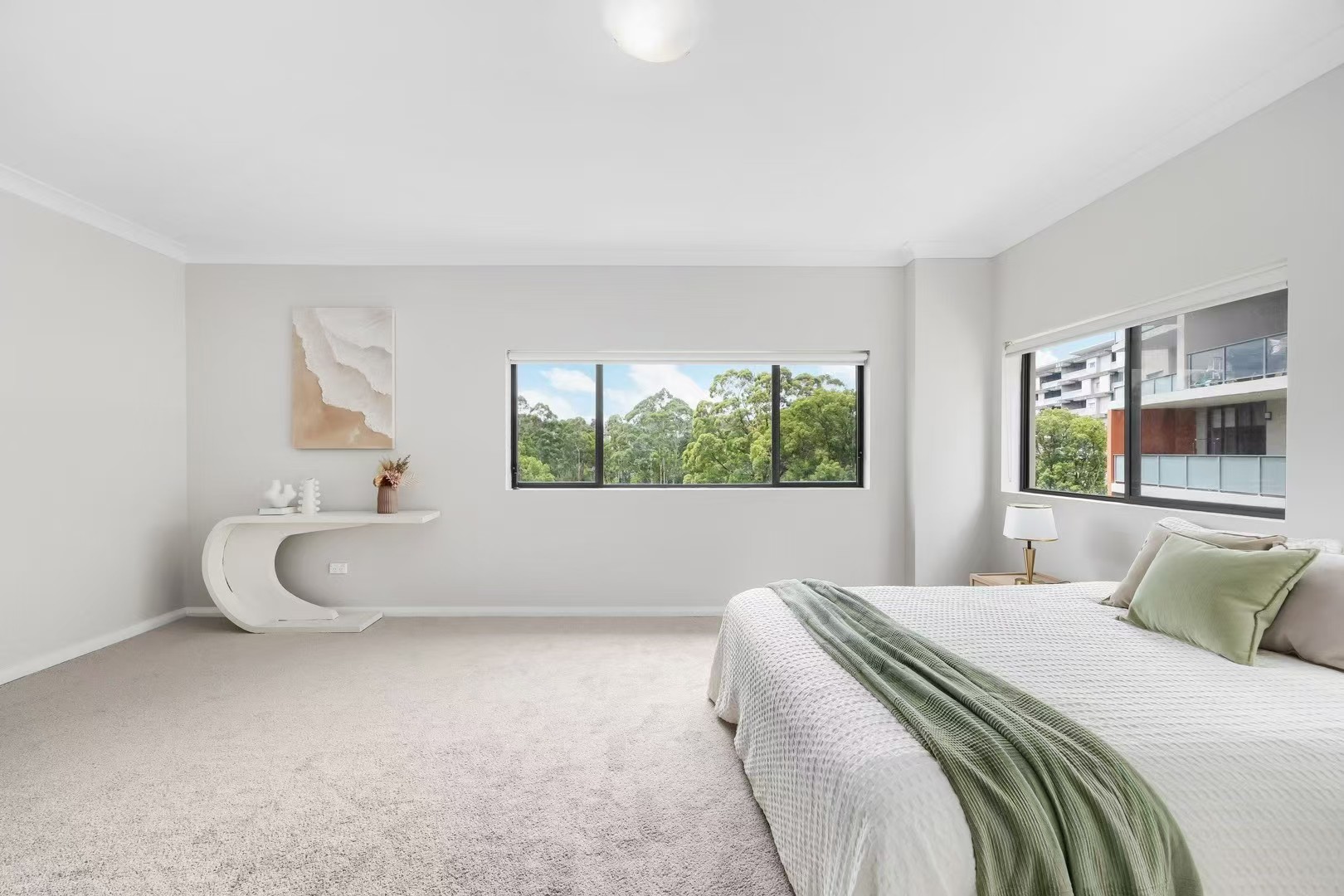 Master bedroom styled with treetop outlook